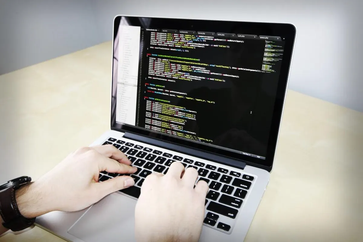Developer writing API code on a laptop